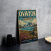 a vintage-style sign for "Ovayok Territorial Park" with a scenic landscape of mountains, water, and flowers.