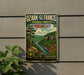A vintage-style metal sign for Ozark-St. Francis National Forests in Arkansas, featuring a scenic landscape with a river, mountains, and pine trees.