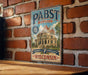 A vintage-style metal sign for Pabst mansion, a Milwaukee's Brewing Heritage, is displayed on a brick wall.
