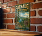 A vintage-style metal sign for the Pachaug State Forest in Connecticut, featuring a scenic landscape with a river and trees.