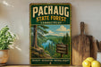 A vintage-style metal sign for the Pachaug State Forest in Connecticut, featuring a scenic landscape with a river and pine trees.
