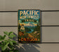 A metal sign with a scenic mountain landscape and the text "PACIFIC NORTHWEST TRAIL OREGON" is displayed on a wall.