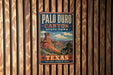 A vintage-style metal sign for the Palo Duro Canyon State Park in Texas, featuring a scenic illustration of the Grand Canyon.