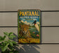 A vintage-style sign for Pantanal Biosphere Reserve in Brazil, featuring a leopard and a bird in a tropical landscape.