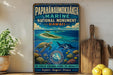 A vintage-style poster advertising the Papahanaumoku'a Marine National Monument in Hawaii, featuring a turtle, a shark, and a coral reef scene.
