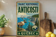 A vintage-style metal sign for the Park National Anticosti in Quebec, featuring a reindeer and a scenic coastal landscape.