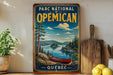 A vintage-style metal sign for the "Parc National d'Émpirean" in Quebec, featuring a canoe on a lake surrounded by pine trees and mountains.