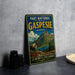 A vintage metal sign for the Gaspésie National Park in Quebec, featuring a deer and a mountain landscape.