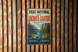 A vintage-style metal sign with the text "PARC NATIONAL de la JACQUES-CARTIER" and "QUEBEC CANADA" is displayed on a wooden wall.