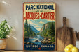 A vintage-style metal sign for the Park National de la Jacques-Cartier in Quebec, Canada, featuring a scenic mountain landscape with a river and pine trees.