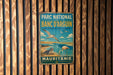 A vintage metal sign with text and illustrations of birds and a seal, mounted on a wooden wall.