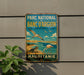 a vintage-style metal sign with a beach scene and birds, mounted on a wall.