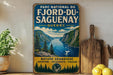 A vintage-style metal sign for the Park National du Fjord-du Saguenay, Quebec, featuring a scenic landscape with mountains, a lake, and pine trees.