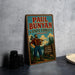 A vintage Paul Bunyan sign advertising the State Forest in Minnesota, featuring a lumberjack holding a chainsaw and standing in front of a sign that says "Big Lakes, Tall Pine, Wild Places".