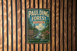 A vintage metal sign for Pauling Forest in Georgia, featuring a scenic illustration of a forest and a stream.