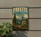 A vintage-style metal sign for the National Forest in Idaho, featuring a scenic landscape with mountains, pine trees, and a lake.