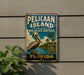 A vintage-style metal sign for Pelican Island National Wildlife Refuge in Florida, featuring a pelican and palm trees.