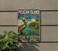 A vintage-style sign for the Pelican Island National Wildlife Refuge, featuring a pelican and a tropical beach scene, mounted on a wall.
