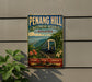 A vintage-style sign for Penang Hill Biosphere Reserve in Malaysia, featuring a train and lush greenery.