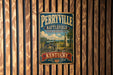 A vintage metal sign for Perryville Battlefield, a state historic site in Kentucky, is displayed on a wooden wall.