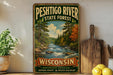 A vintage-style sign for the Peshtigo River State Forest in Wisconsin, featuring a scenic illustration of a river surrounded by pine trees and autumn foliage.