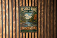 A vintage metal sign for the Peshtigo River State Forest in Wisconsin, featuring a scenic image of a river surrounded by pine trees and autumn foliage.