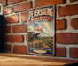 A vintage metal sign displaying the name "Petersburg National Battlefield Virginia" with an American flag and a cannon, mounted on a brick wall.
