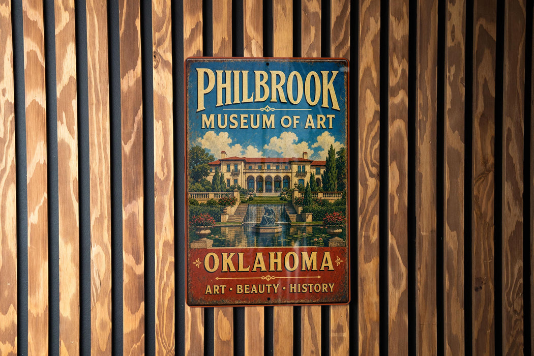 A vintage metal sign for the Philbrook Museum of Art in Oklahoma, featuring an illustration of a building with a fountain in the foreground.