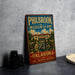 a vintage-style sign for the Philbrook Museum of Art in Oklahoma, with a large illustration of the museum's architecture and a fountain in the foreground.