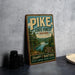 A vintage-style metal sign for Pike State Forest, Indiana, featuring a scenic illustration of the forest and a lake.