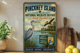 A vintage-style sign for Pinchney Island National Wildlife Refuge in South Carolina, featuring illustrations of birds and a serene landscape.