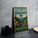 A vintage-style metal sign for Pisgah National Forest in North Carolina, featuring a scenic landscape with a waterfall and pine trees.