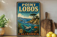 A vintage-style sign for Point Lobos State Marine Reserve in California, featuring an illustration of a seal swimming in the ocean.
