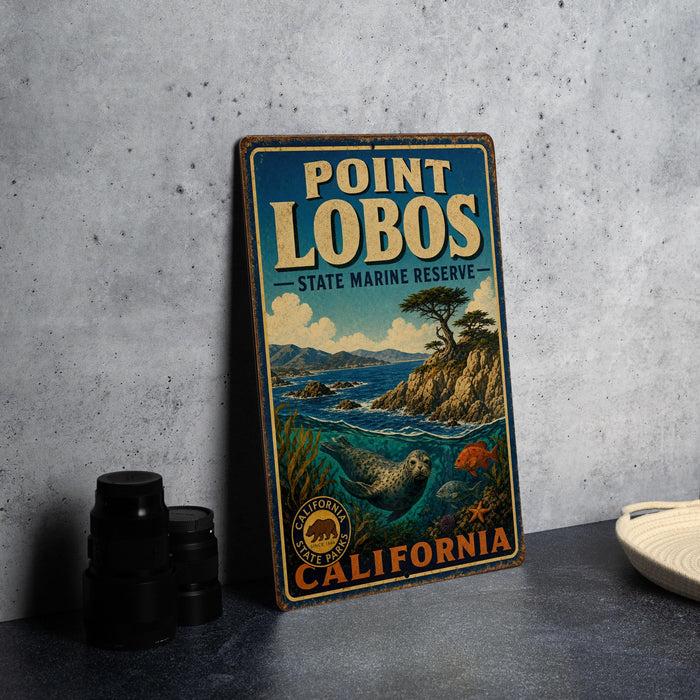 A vintage metal sign for Point Lobos State Marine Reserve, featuring an illustration of a coastal landscape with a seal and a lighthouse.