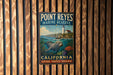 A vintage-style metal sign for Point Reyes Marine Reserve in California, featuring a lighthouse and marine life.