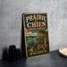 A vintage-style sign for Prairie du Chien, Wisconsin, featuring an illustration of a river, buildings, and a steamboat.