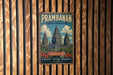 A vintage-style metal sign with the text "Prambanan Temple Compounds" and "Indonesia" is displayed on a wooden wall.