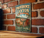 A vintage-style metal sign for Providence Canyon, Georgia, mounted on a brick wall.