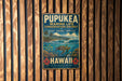 A vintage metal sign for the Pupukea Marine Life Conservation District in Hawaii, featuring a tropical beach scene with a turtle and colorful flowers.