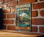 A vintage-style metal sign with the text "PUHONUA O HONAaunau" and "NATIONAL HISTORICAL PARK" is displayed on a brick wall.