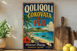 A vintage-style sign advertising "Qoliqoli, Cokovata, Fiji" with a tropical beach scene and a sailboat, placed on a wooden surface next to a potted plant and some lemons.