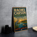 A vintage-style sign for Rachel Carson Estuarine Reserve in North Carolina, featuring a seagull, turtle, and other wildlife in a scenic landscape.