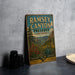 a vintage-style sign for Ramsey Canyon Preserve, Arizona, with a mountain landscape and desert scene depicted on it.