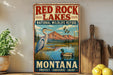 A vintage-style metal sign for the Red Rock Lakes National Wildlife Refuge in Montana, featuring an illustration of a heron and ducks in a lake surrounded by mountains.