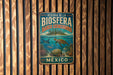 A metal sign with text and an illustration of a tropical underwater scene, mounted on a wooden wall.