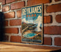 A vintage-style metal sign for Reykjanes Park, Iceland, featuring a scenic illustration of the park's landscape and a lighthouse.