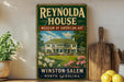 A vintage-style sign for the Reynolds House Museum of American Art in Winston-Salem, North Carolina, featuring a painting of a large white house surrounded by flowers and greenery.