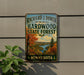 A vintage-style metal plaque with the text "RICHARD J. DORER MEMORIAL HARDWOOD STATE FOREST MINNESOTA" is displayed on a wall, with a plant to the left.