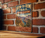 A vintage-style metal sign for the Rim-to- Rim Trail in Grand Canyon, Arizona, featuring a scenic image of the Grand Canyon and trail signs.