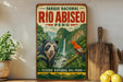 A vintage-style poster advertising the Parque Nacional Rio Abisito in Peru, featuring a bear and a bird in a lush, tropical landscape.